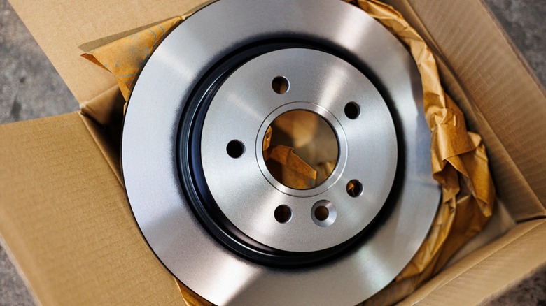 A fresh brake rotor in a box ready for installation.