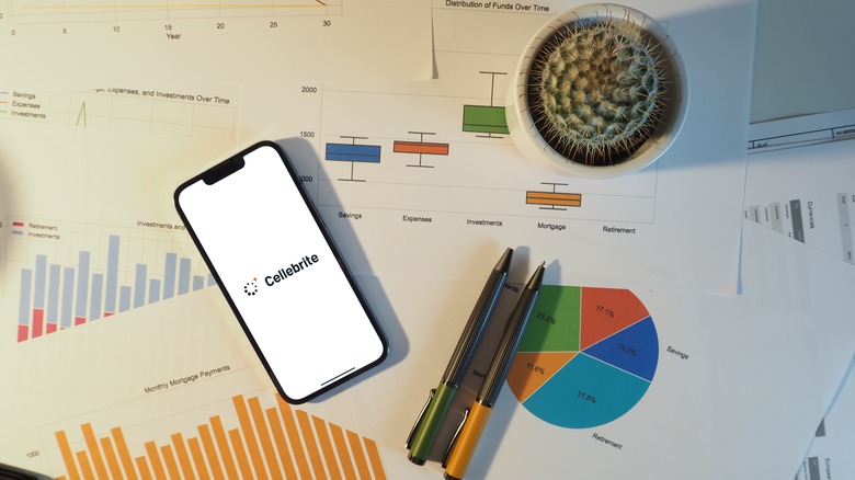 Cellebrite logo on smartphone surrounded by sensitive documents