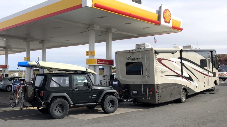a Jeep Wrangler being flat towed behind an RV