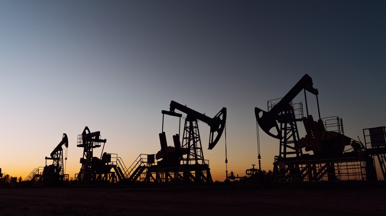 Several oil pumpjacks at dusk