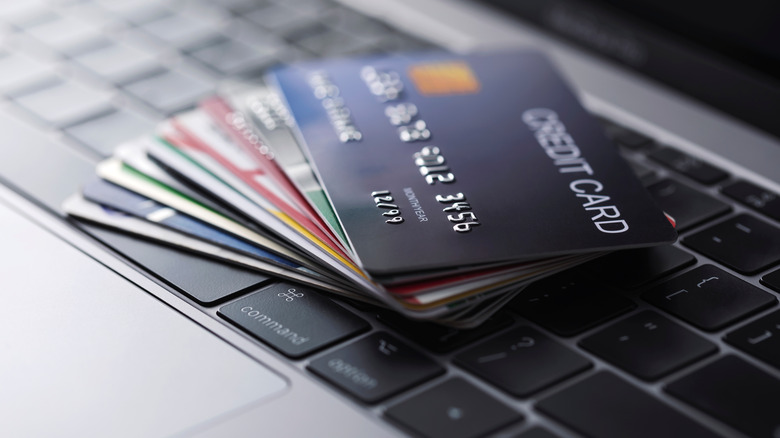 Stack of credit cards on laptop