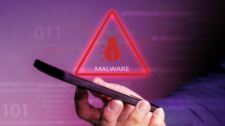 Person holding smartphone with malware warning overlay
