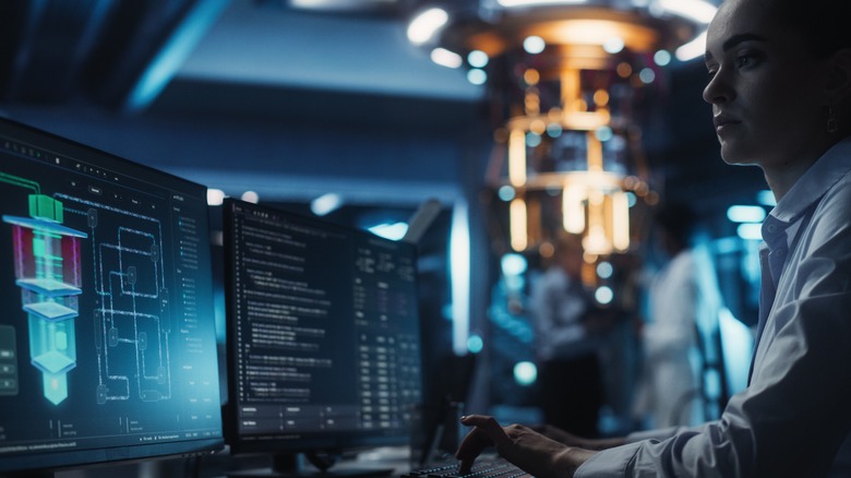 Smart Female Engineer Working Behind a Desk on a quantum computer.