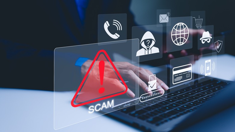 A person using laptop, warning sign for scams with icons representing online threats, phishing, and cybersecurity.
