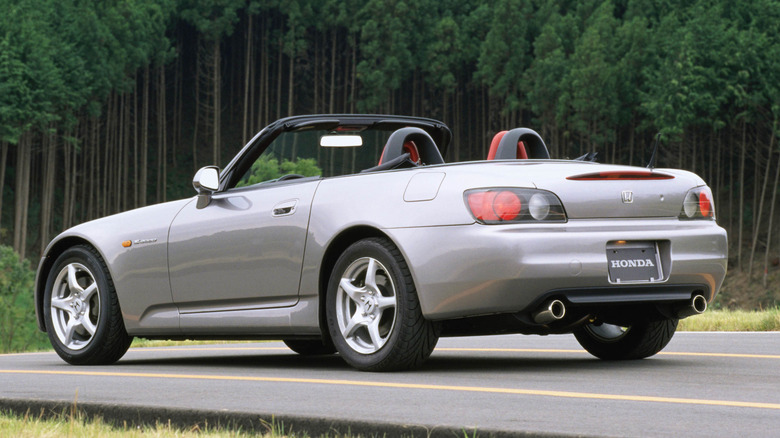 Rear 3/4 view of Honda S2000 in silver with the roof down