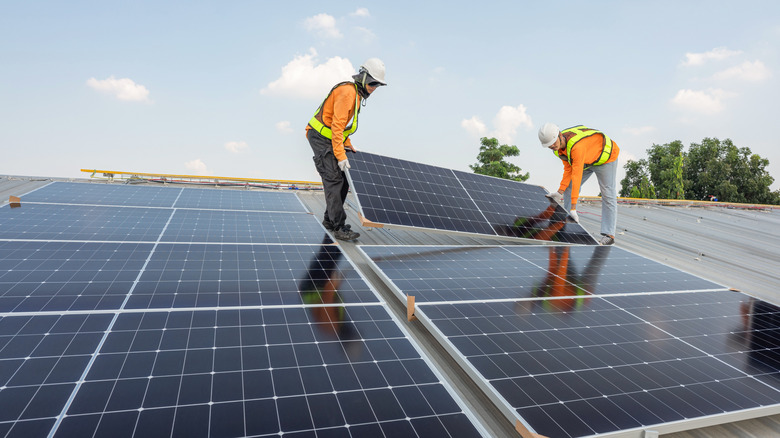 Technicians installing solar panals
