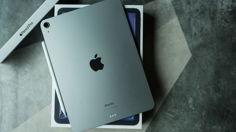 An iPad Air sitting on its box with an Apple Pencil Pro box and pencil nearby
