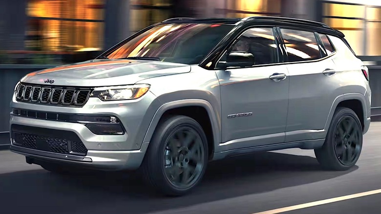 A Jeep Compass driving on a city road.