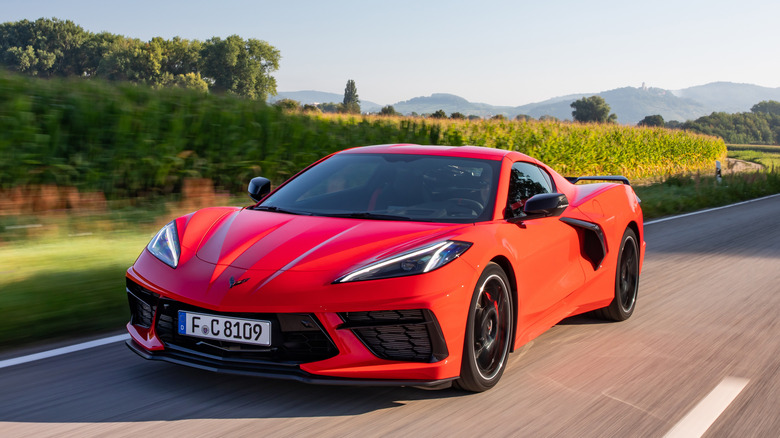 Front 3/4 view of Chevrolet Corvette C8 in orange on the move