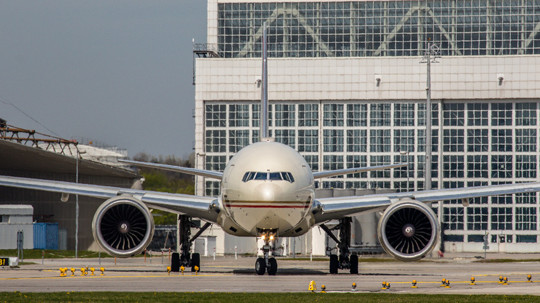 A Boeing 777 aircraft powered by twin GE-90 engines taxiing at an airport