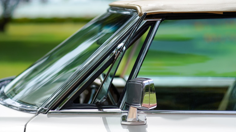 A Cadillac with its vent window open.