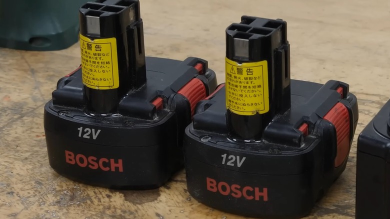 Two Bosch nickel-cadmium batteries on a table.