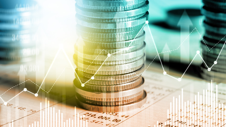 Stack of coins on financial documents