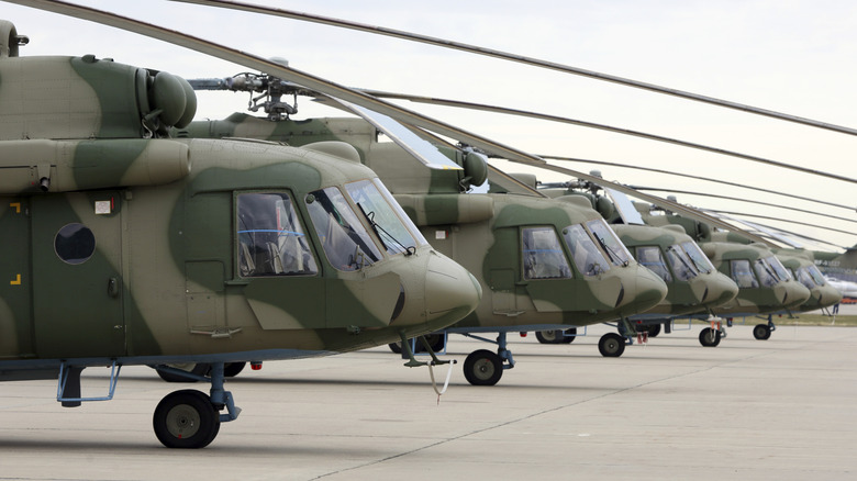 A parked line up of Mi-8 military helicopters