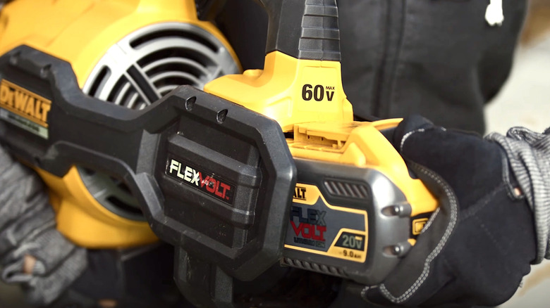 Person putting battery into DeWalt leaf blower