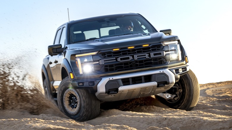 Ford F-150 Raptor driving through sandy terrain