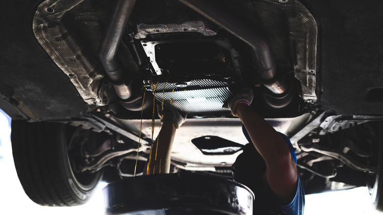 Mechanic removing transmission oil pan