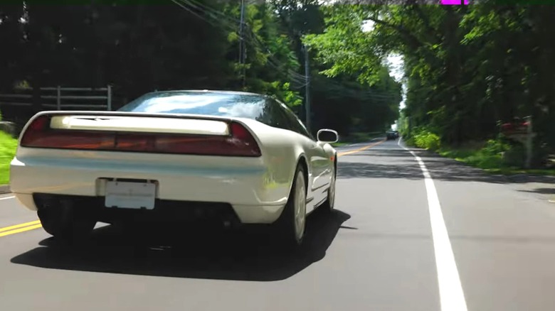 white NSX type R on two-lane road
