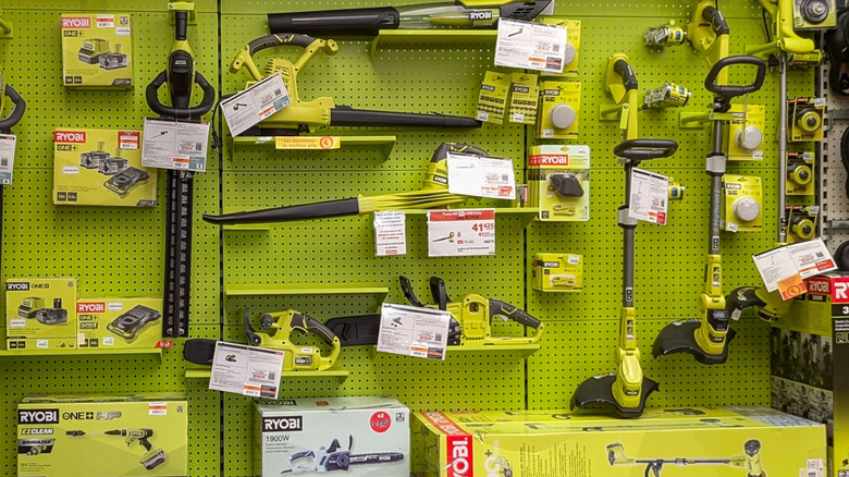A collection of Ryobi tools and accessories on a store wall