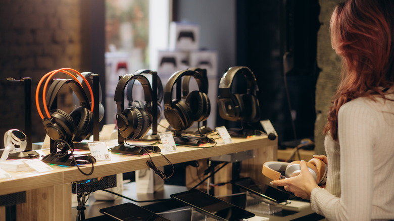 Woman buying headphones in store