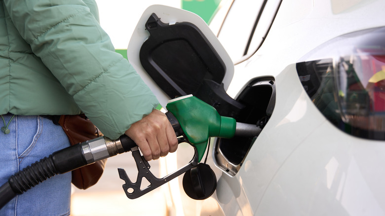 Diesel gas pump in white car