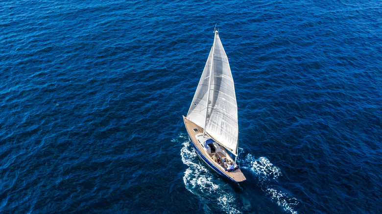 Aerial view of a Classic sail boat sailing in the open Mediterranean sea.