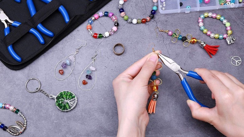 person making earrings