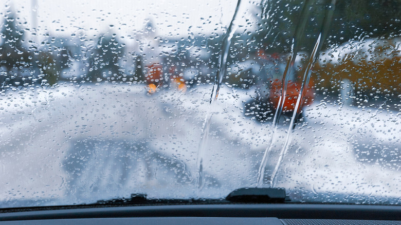 A view of a wet windshield from the inside of a car