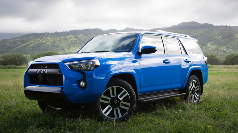 A front 3/4 shot of a 2020 Toyota 4Runner 1919 Waialua edition parked in a green field with name in the bottom corner of photo.