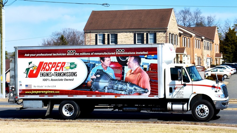 A side view of a Jasper Engines & Transmissions truck on the road
