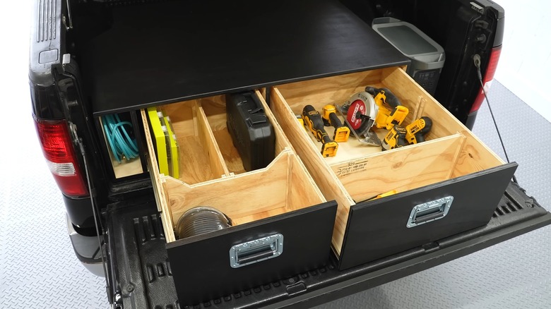 A Homemade Truck Tool Box Painted Black With Multiple Drawers