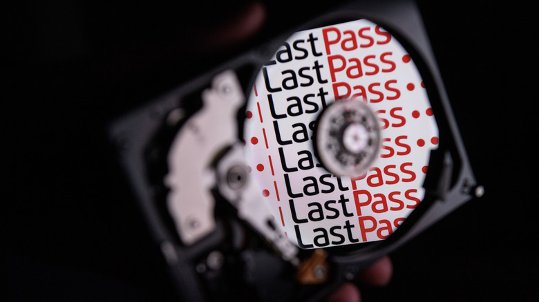 the logo for online password manager service "LastPass" is reflected on the internal discs of a hard drive