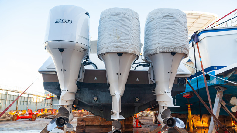 An up-close shot of three outboard engines on a speedboat