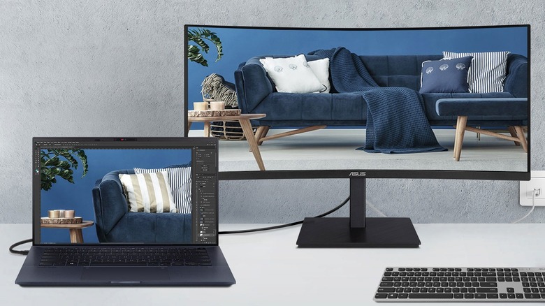ASUS 21:9 ultra-wide monitor connected to laptop on a table