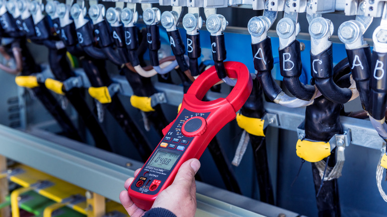 Person checking solar panel operating voltage