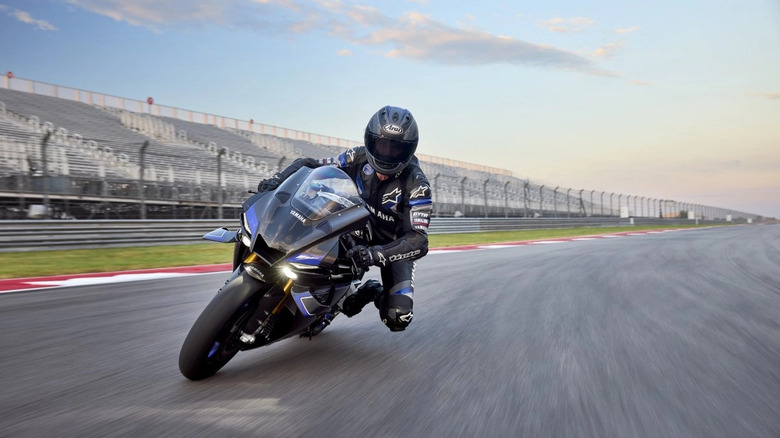 A person riding a Yamaha R1M on a race track