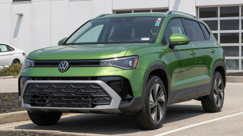 Green Volkswagen Taos SE compact SUV in parking lot