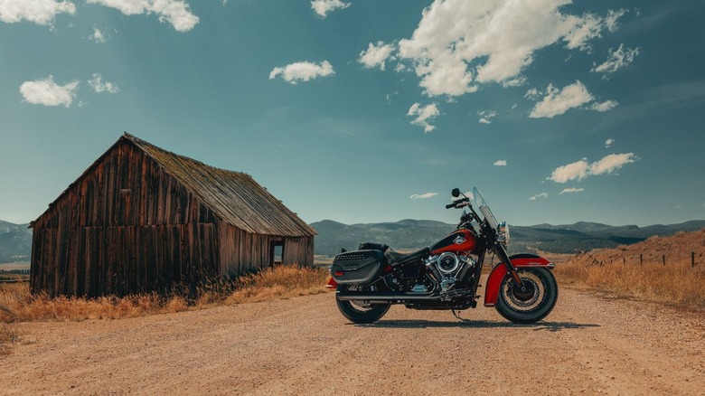 Red Heritage Classic parked outside barn in desert