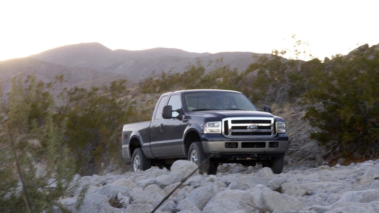 2006 Ford F-350 Super Duty on rocky terrain, front-right 3/4 view