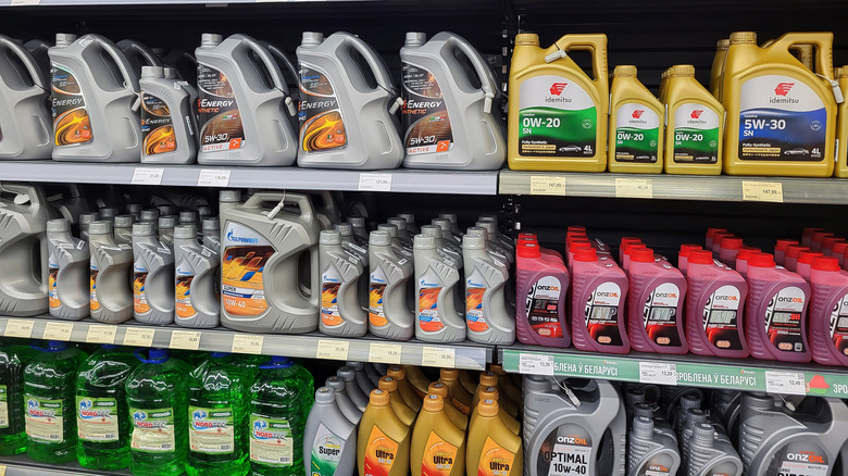 Selection of motor oil cans and bottles stocked on store shelf