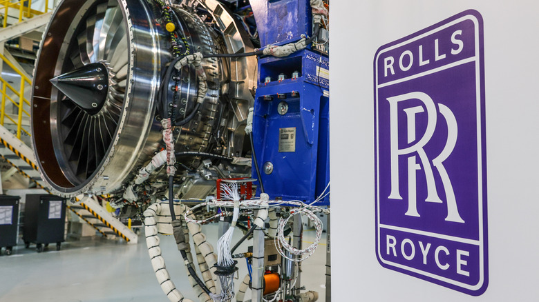 Rolls-Royce logo with a jet engine in the background at the company's factory in Berlin