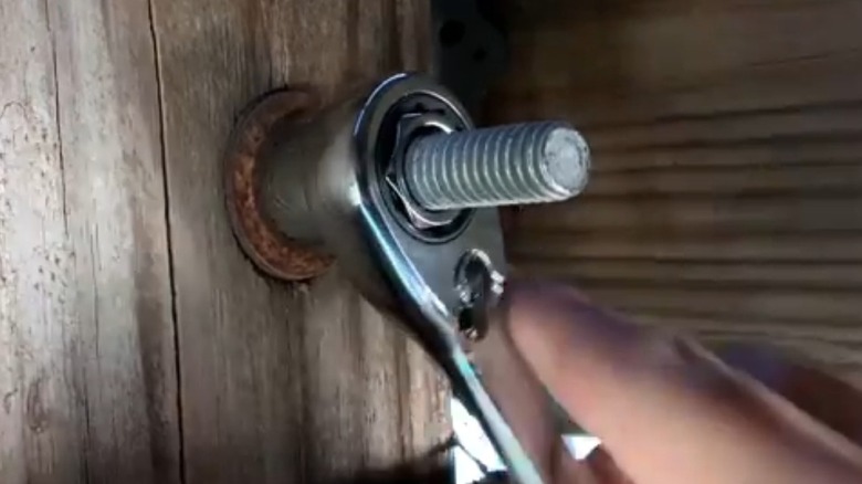 Using a pass-through socket to access a nut on a long stud.