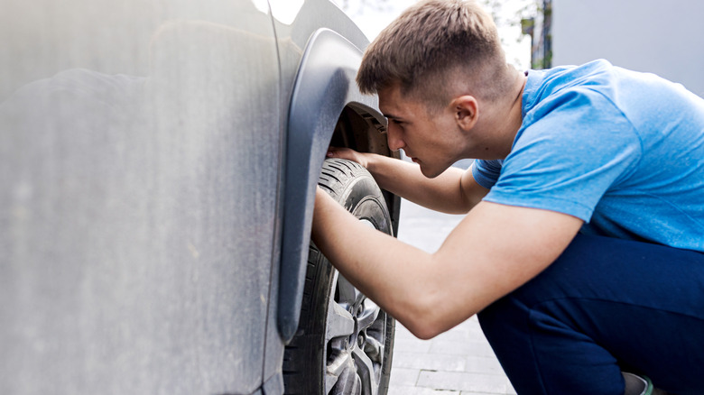 Man checking condition of a tire