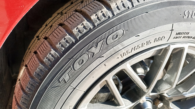 Close-up of a TOYO winter tire on a red vehicle