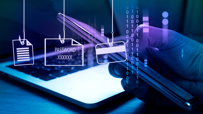 A phone being held in front of a macbook with graphics over the top showing fishing hooks with documents, passwords, and a credit card. The image has a purple-blue shift and binary over it.
