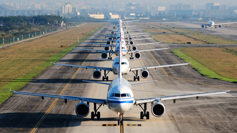 Airplanes in line on a runway waiting for take off
