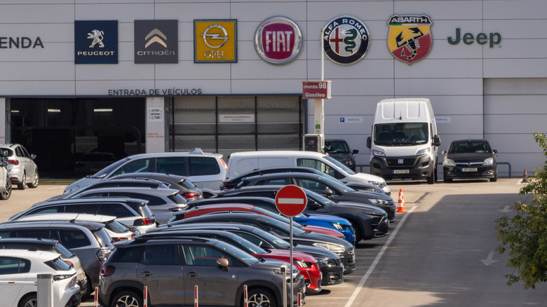 A Stellantis dealership and service center with the badges of some major brands on display.