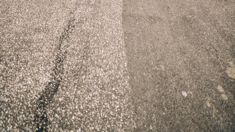 A Rolls-Royce Ghost and a Bentley Flying spur standing side by side on a palm-tree-lined boulevard.