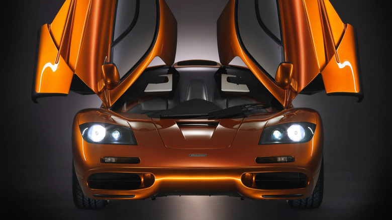 Front view of a McLaren F1 with butterfly doors open