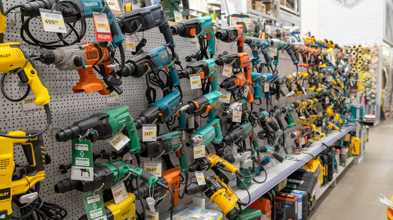 Various power tools including rotary hammers line shelves